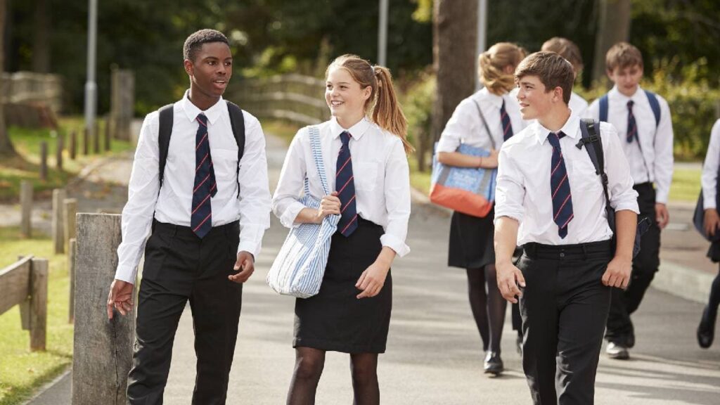 Three pupils walking to high school for the first time as they are transitioning from year 6 to year 7