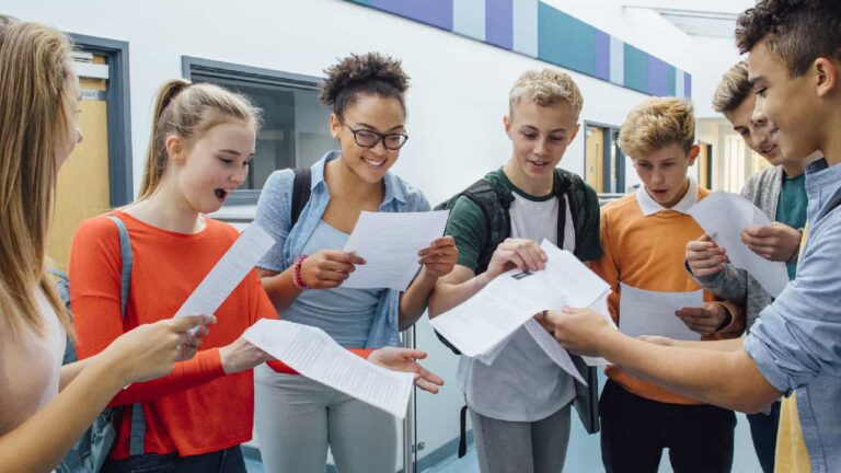 Students getting exam results in their school