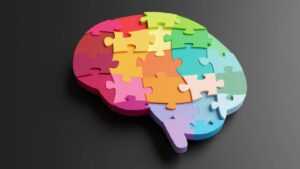 in this blog we look at how educators can support neurodiversity in the classroom. The image used multi-coloured jigsaw puzzles forming the shape of a brain on black background. Illustration of the concept of intelligence, wisdom, ideas and creativity