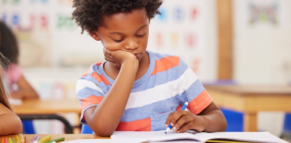Young black child struggling with school as he is a autistic moment.