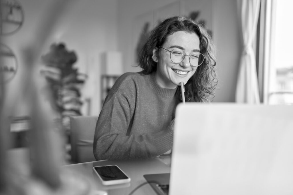 woman working on laptop smiling