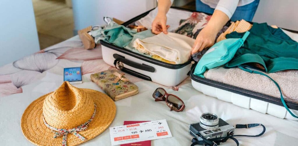 White female teacher woman preparing suitcase for summer holidays.