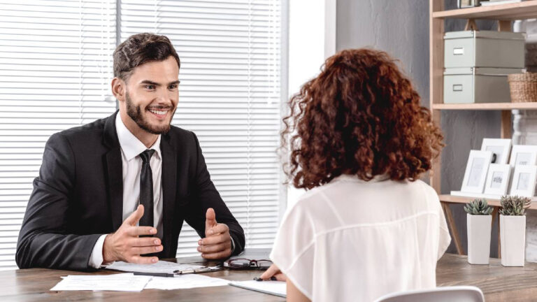 Job Interview. Headmaster talking with candidate smiling cheerful sitting in school office