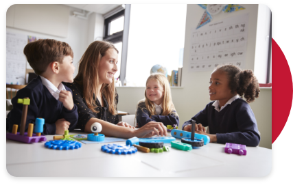 teacher speaking with 3 children