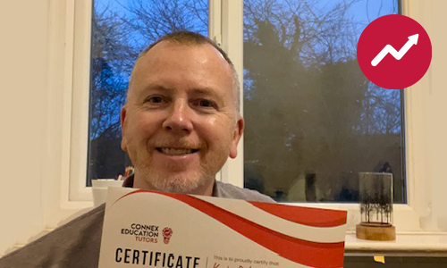 Kevin holding his tutor certificate