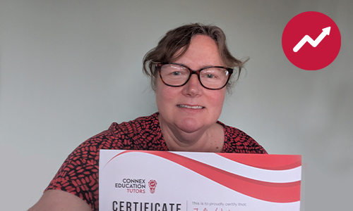 Julia holding her tutor certificate