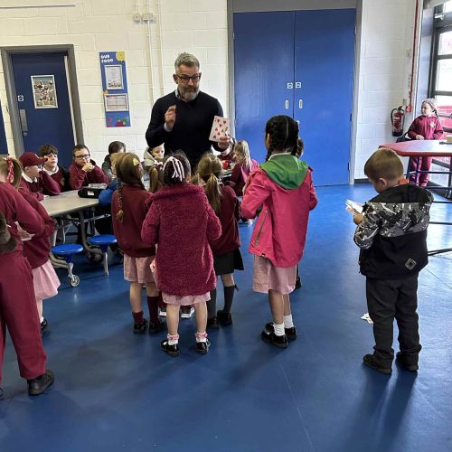 Paul playing a game with the children at breakfast club