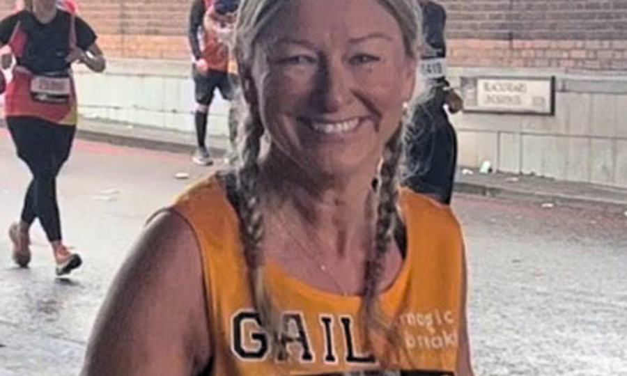 Woman running the London Marathon and smiling