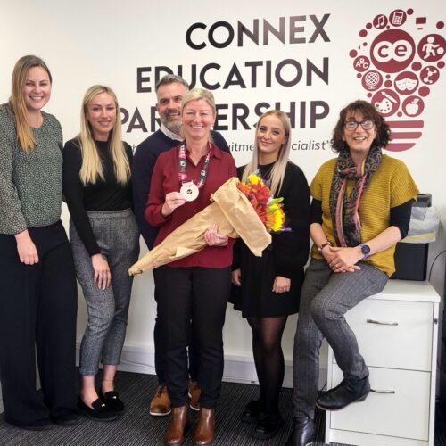 Gail being given flowers by her team